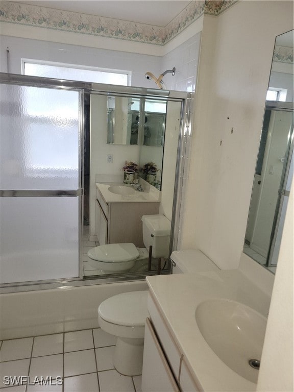 full bathroom featuring toilet, shower / bath combination with glass door, vanity, and tile patterned floors