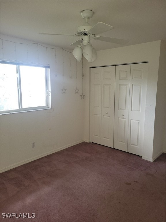 unfurnished bedroom with carpet, ceiling fan, and a closet