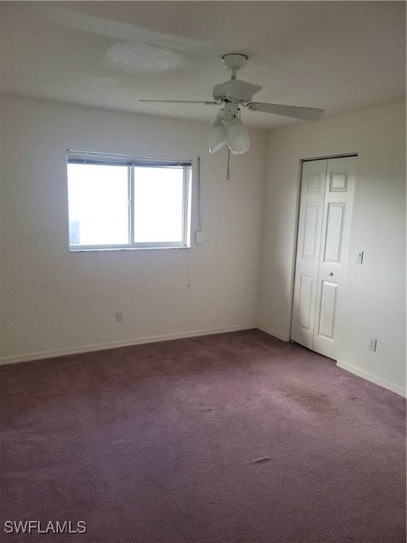 spare room featuring ceiling fan and carpet flooring