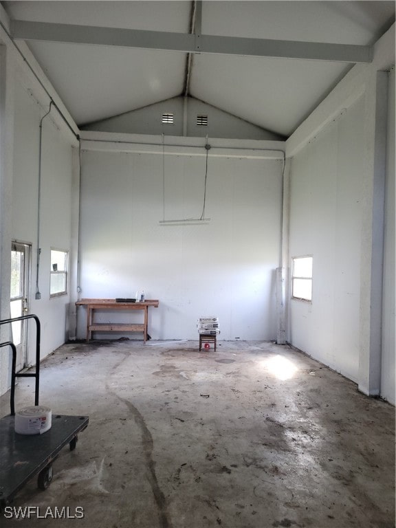 misc room with lofted ceiling with beams