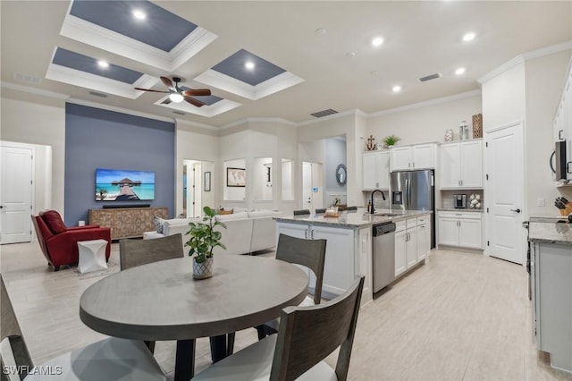 dining area featuring visible vents, coffered ceiling, a towering ceiling, and ornamental molding