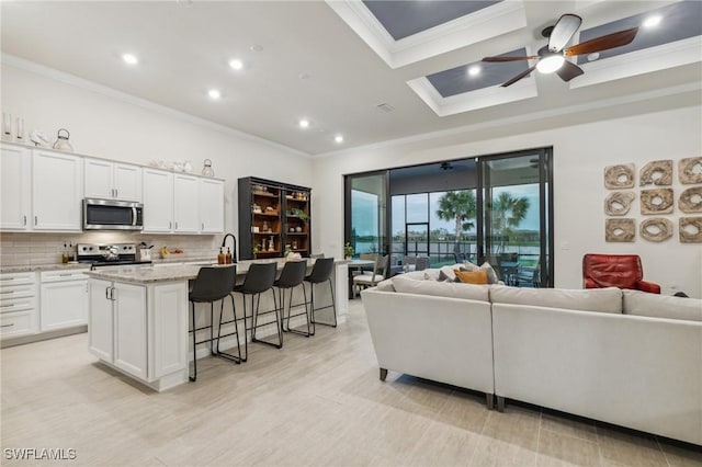 living room with crown molding, recessed lighting, light wood-type flooring, and ceiling fan