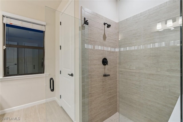 full bath with baseboards and tiled shower