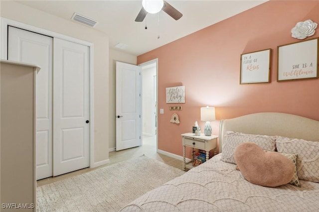 bedroom featuring a ceiling fan, baseboards, visible vents, and a closet