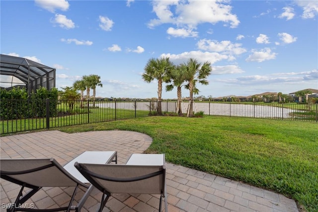 view of yard with a patio, a fenced backyard, and a water view