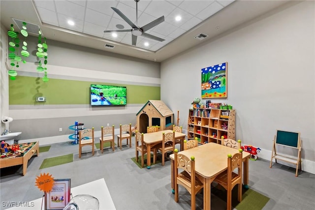 game room with a ceiling fan, visible vents, and a drop ceiling