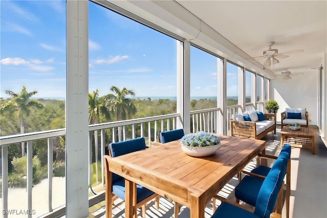 sunroom / solarium featuring ceiling fan