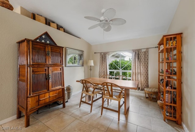 tiled dining space with vaulted ceiling and ceiling fan