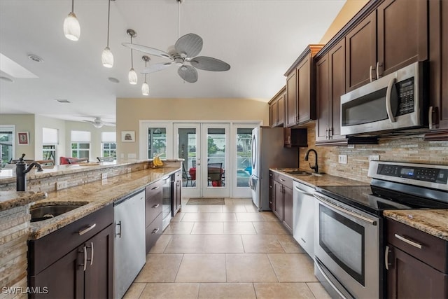 kitchen with dark brown cabinetry, sink, appliances with stainless steel finishes, and french doors