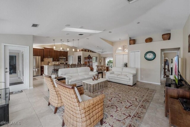 1512 SW 4th Ct, Cape Coral, FL 33991 - living area featuring lofted ceiling, baseboards, and light tile patterned flooring