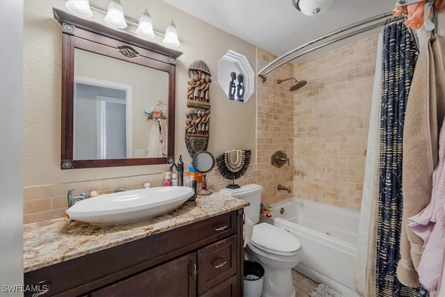 full bathroom featuring shower / bath combination with curtain, toilet, and vanity