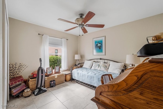 tiled bedroom featuring ceiling fan