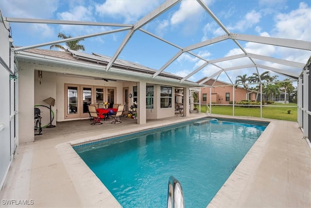 view of swimming pool with a lanai and a patio