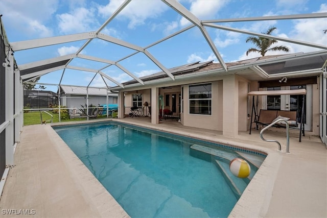 view of swimming pool featuring a patio area and a lanai