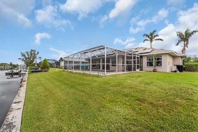 1512 SW 4th Ct, Cape Coral, FL 33991 - view of grassy yard featuring glass enclosure and a patio