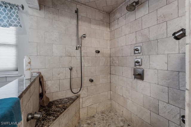 bathroom with a tile shower