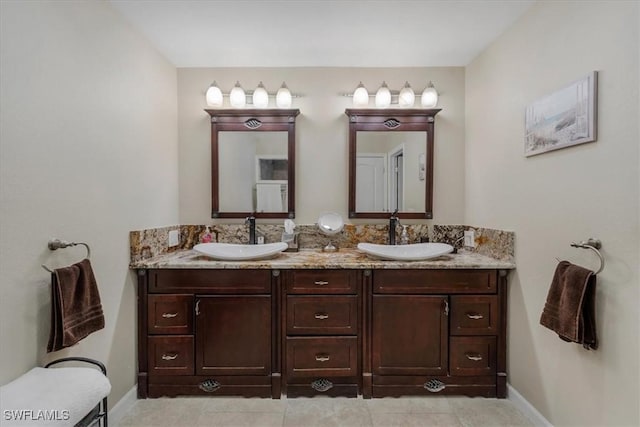 1512 SW 4th Ct, Cape Coral, FL 33991 - bathroom with double vanity, tile patterned floors, and baseboards