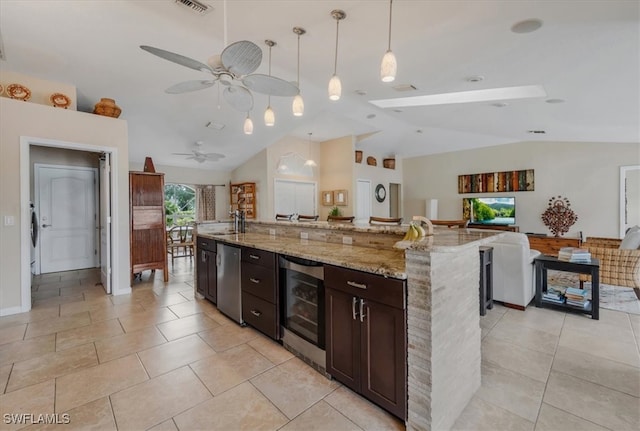 kitchen with a spacious island, wine cooler, vaulted ceiling, decorative light fixtures, and dark brown cabinetry