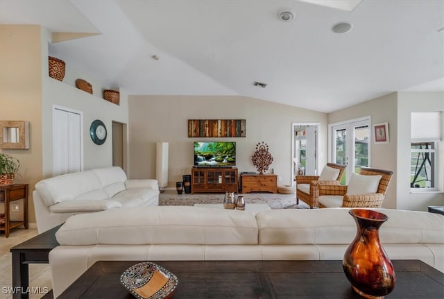 living room with french doors and lofted ceiling