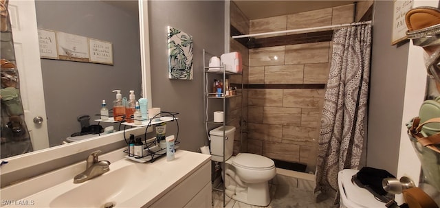 bathroom featuring toilet, a shower with curtain, and vanity