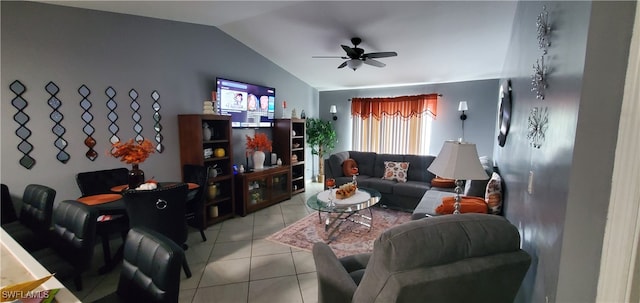 living room featuring vaulted ceiling, light tile patterned floors, and ceiling fan