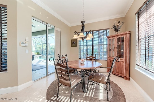 dining room with a wealth of natural light, crown molding, and an inviting chandelier