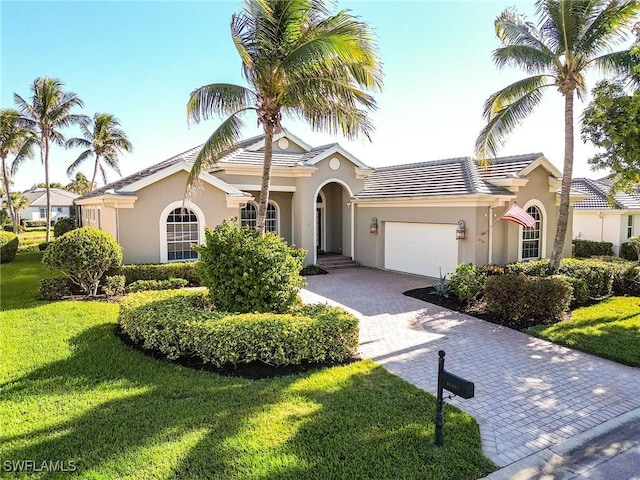 view of front facade with a garage and a front lawn