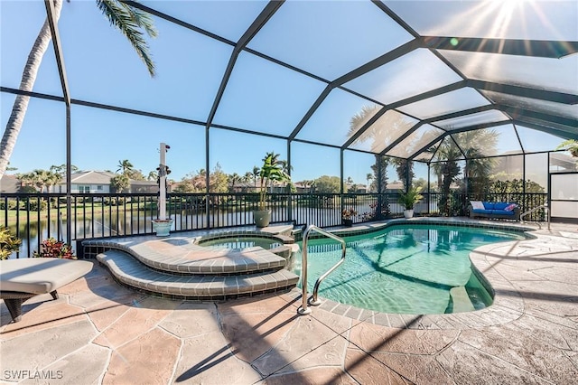 view of swimming pool featuring glass enclosure, a patio area, a water view, and an in ground hot tub