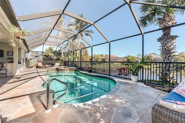 view of swimming pool with a water view, glass enclosure, and a patio area