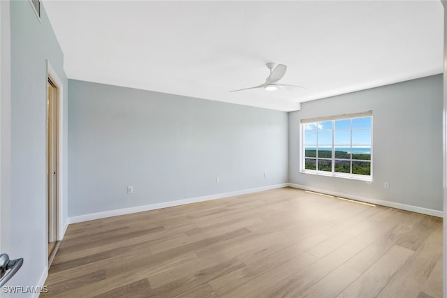 unfurnished room with ceiling fan and light wood-type flooring