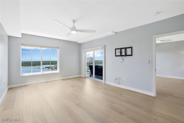 unfurnished room featuring light hardwood / wood-style flooring and ceiling fan