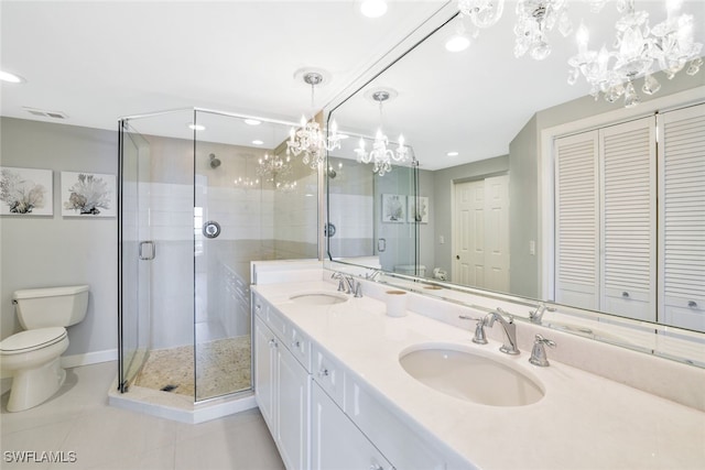 bathroom with tile patterned flooring, vanity, toilet, and a shower with shower door