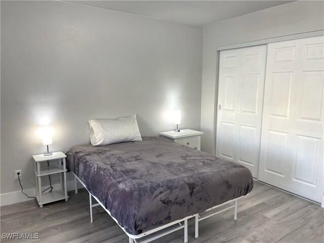 bedroom with hardwood / wood-style flooring and a closet