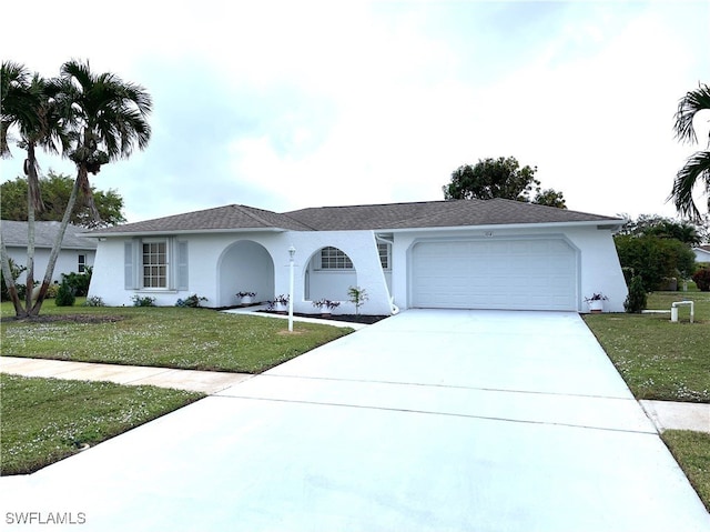 single story home featuring a garage and a front yard