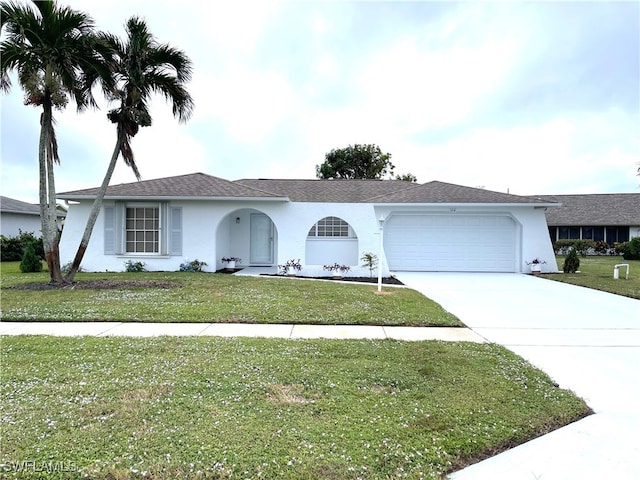 ranch-style home with a garage and a front lawn