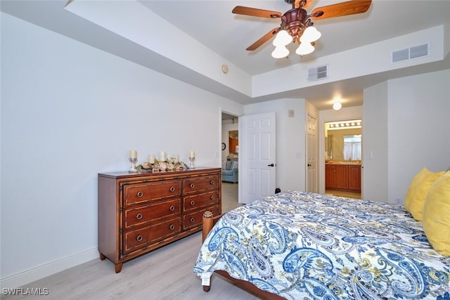 bedroom with light wood-style flooring, ensuite bath, baseboards, and ceiling fan
