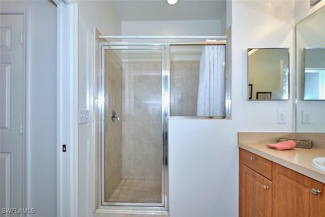 full bath with a stall shower and vanity