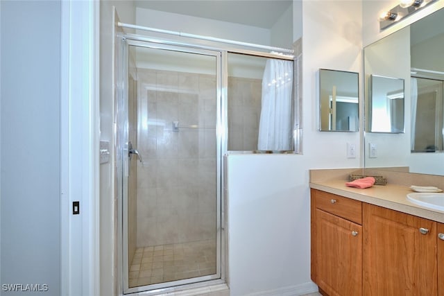 bathroom featuring a stall shower and vanity