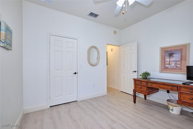 home office with ceiling fan and light hardwood / wood-style flooring