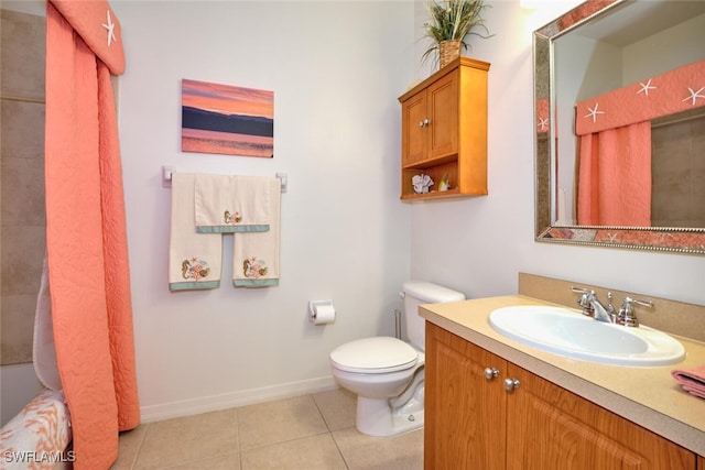full bath with tile patterned floors, toilet, vanity, and baseboards