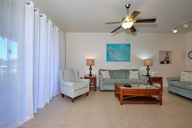 tiled living room featuring rail lighting and ceiling fan