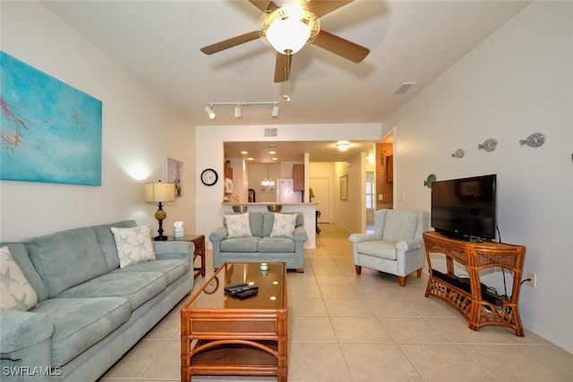 living room featuring light tile patterned floors, a ceiling fan, and rail lighting