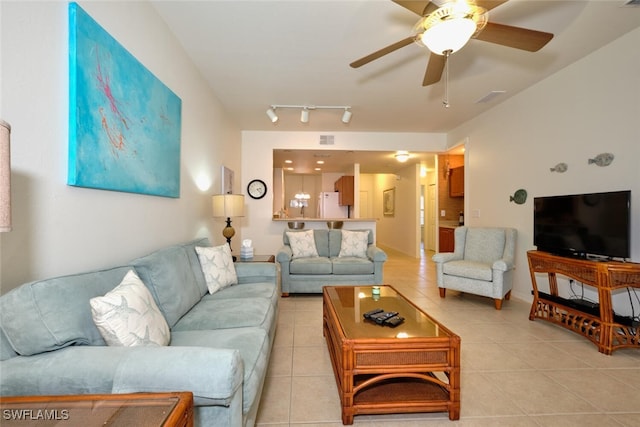 living room featuring ceiling fan, track lighting, and light tile patterned flooring