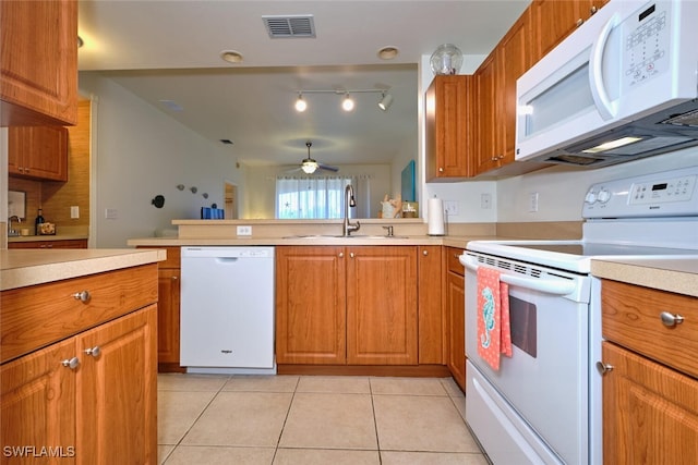 kitchen with sink, white appliances, ceiling fan, and light tile patterned floors