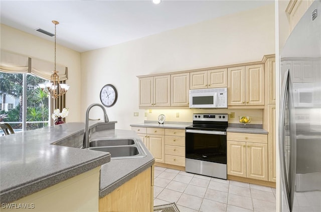 kitchen featuring stainless steel appliances, decorative light fixtures, light brown cabinetry, sink, and a chandelier