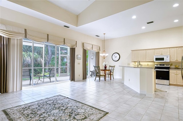 kitchen with light tile patterned flooring, a notable chandelier, decorative light fixtures, and electric stove