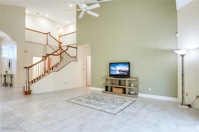 living room with ceiling fan, light tile patterned floors, and high vaulted ceiling