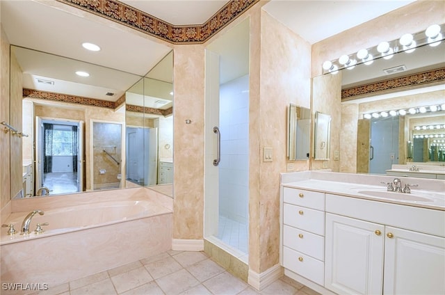 bathroom with tile patterned flooring, vanity, and independent shower and bath