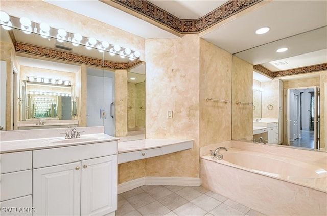 bathroom featuring vanity, tile patterned flooring, and a bathtub