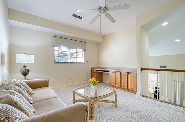 carpeted living room featuring ceiling fan